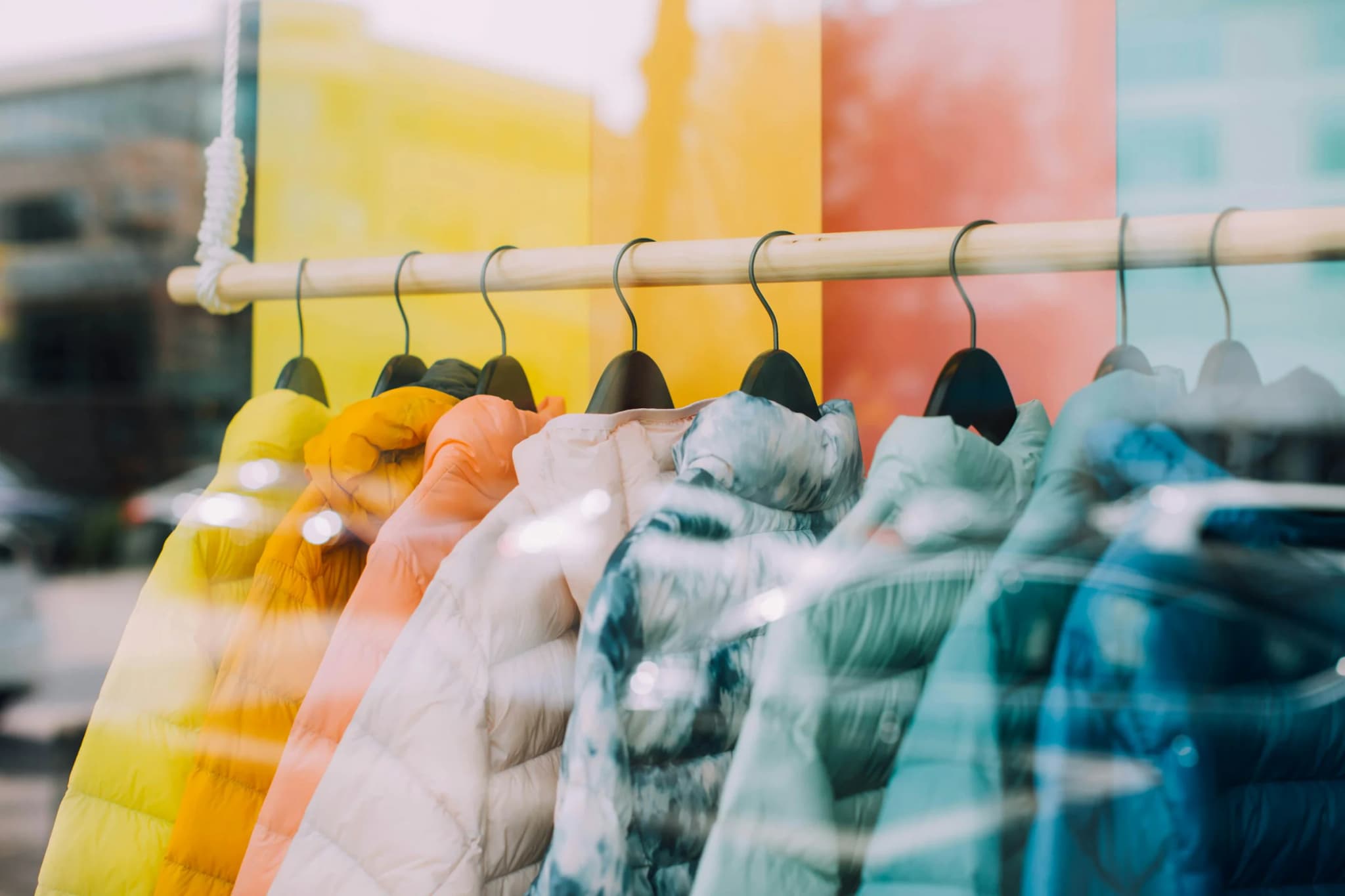 Rail of colourful jackets in soft light