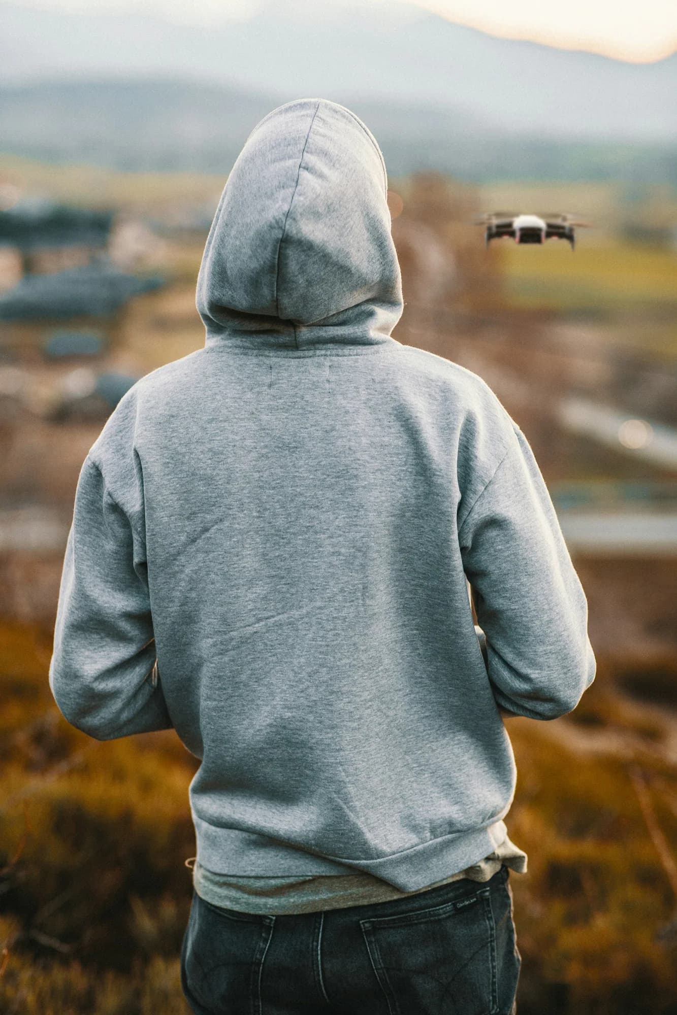 Person wearing a grey hoodie seen from behind