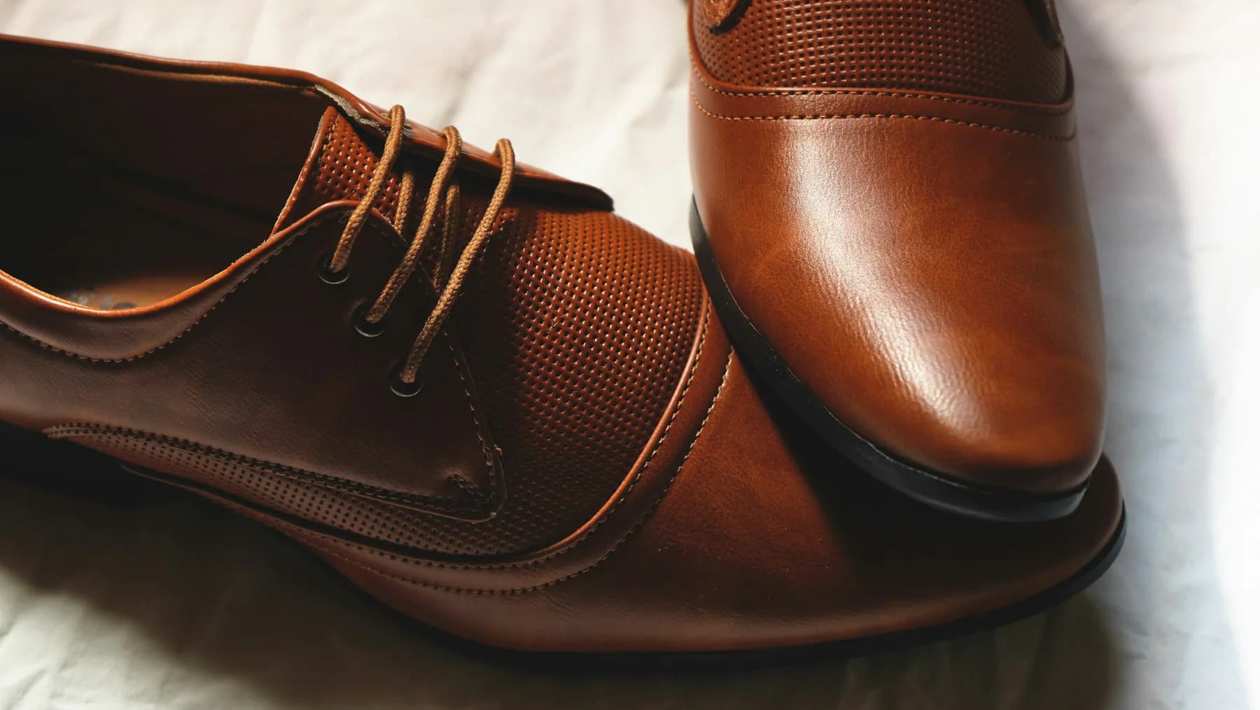 Close-up of cognac brown leather derby shoes