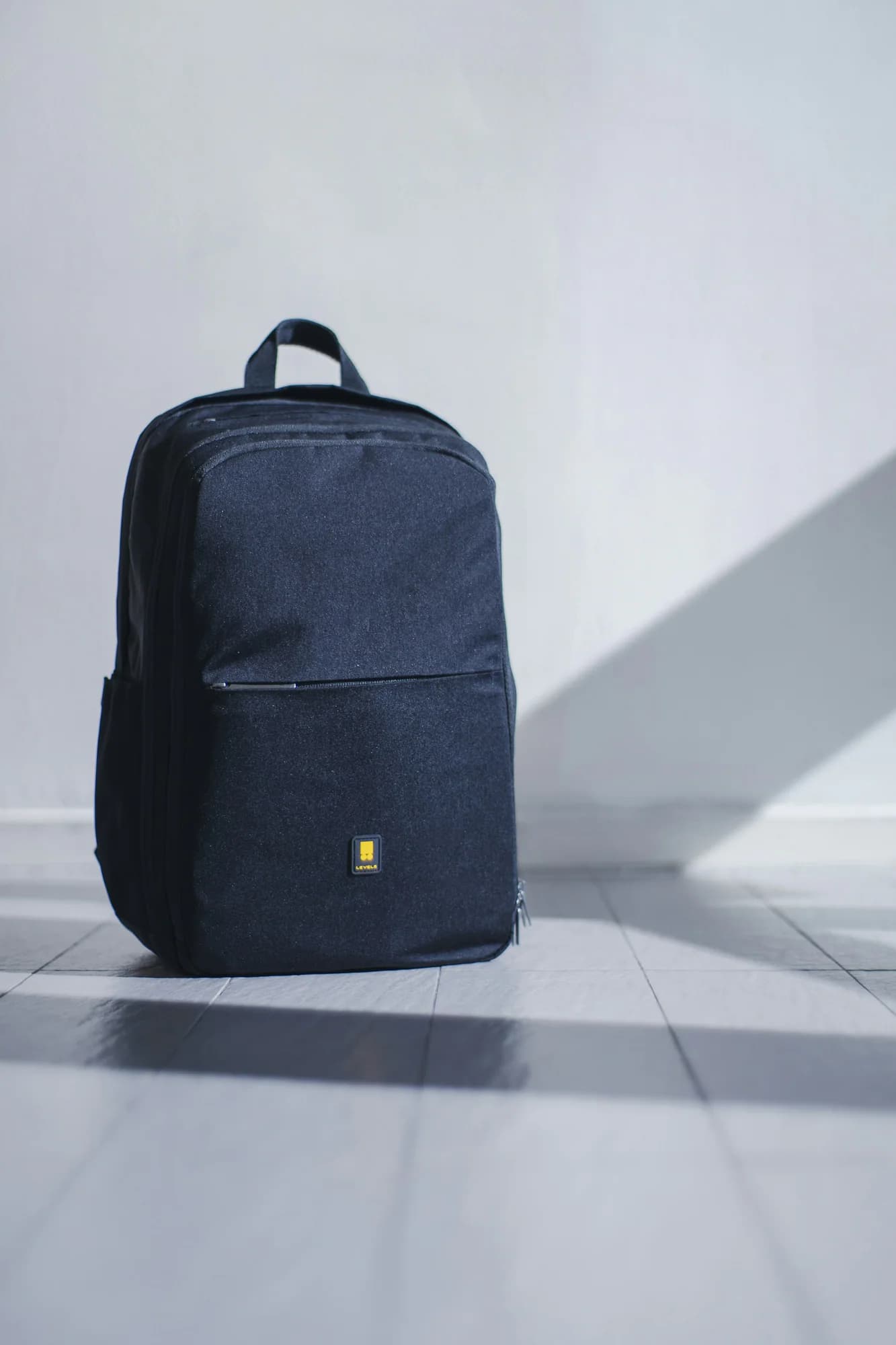 Navy backpack on a light grey background