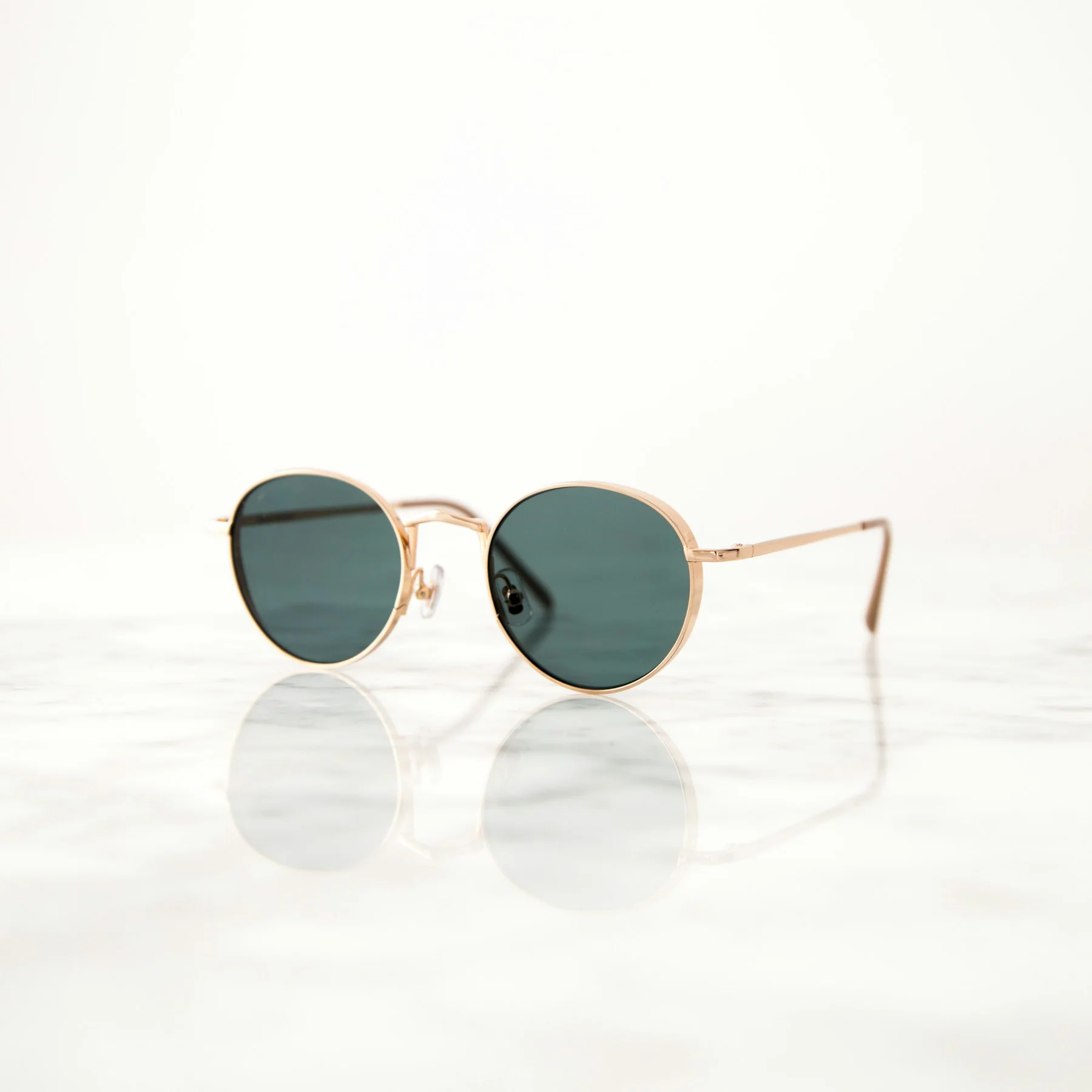 Round gold wire sunglasses with green lenses