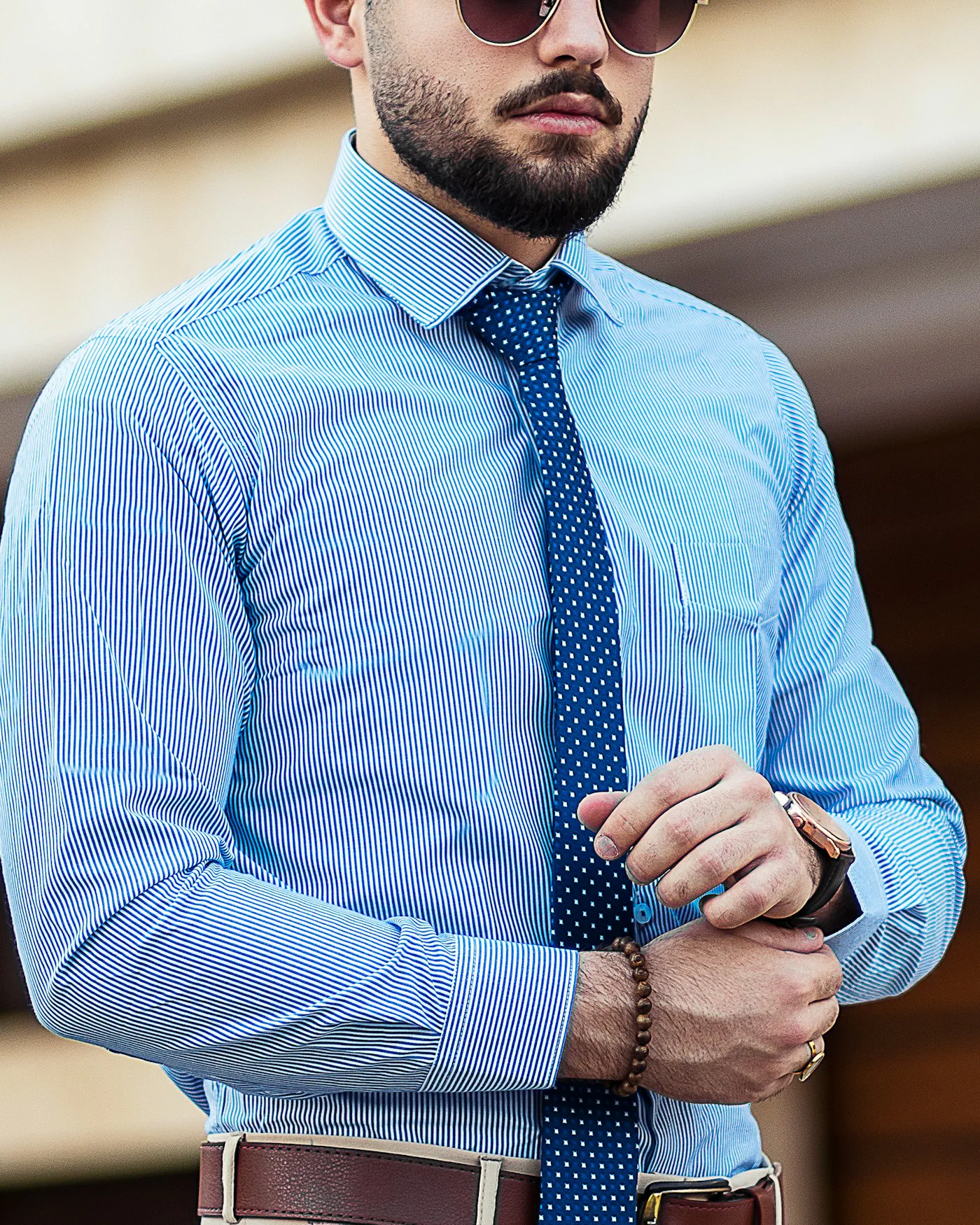 Man wearing a light blue dress shirt and tie — detail