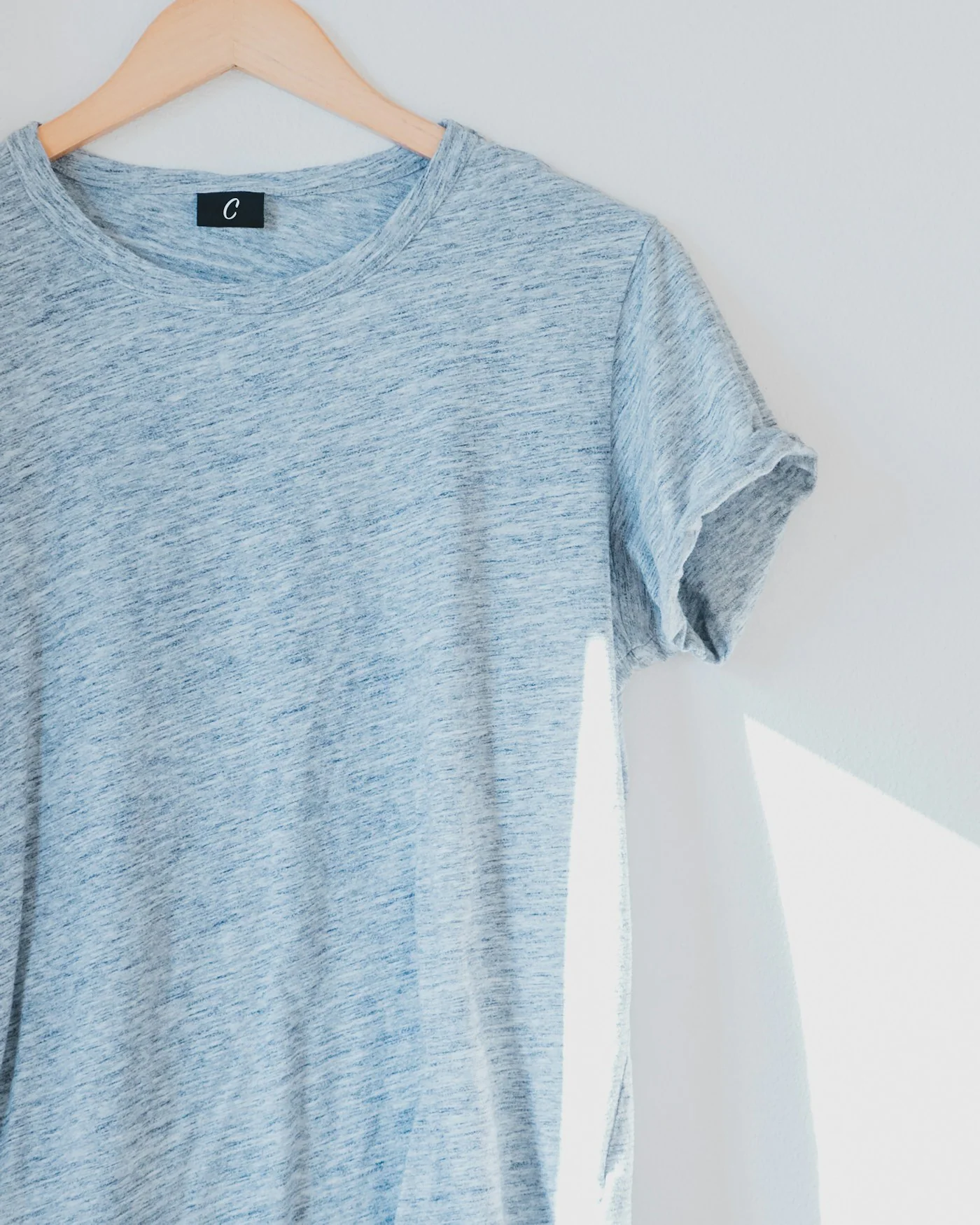 Heather grey crewneck t-shirt on a hanger — detail