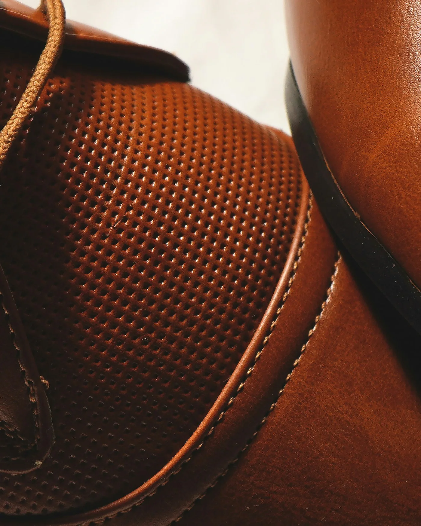 Close-up of cognac brown leather derby shoes — detail