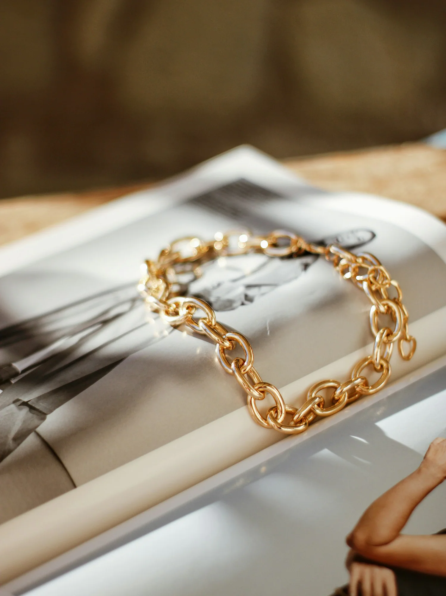 Gold curb chain bracelet on a book page