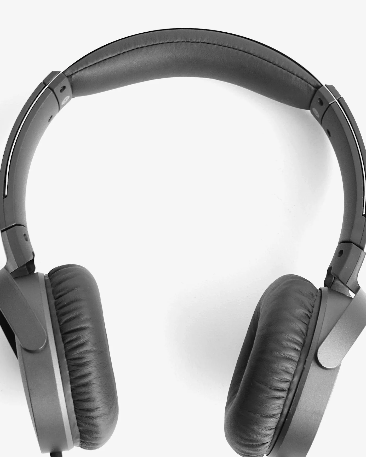 Black studio monitor headphones on white — detail