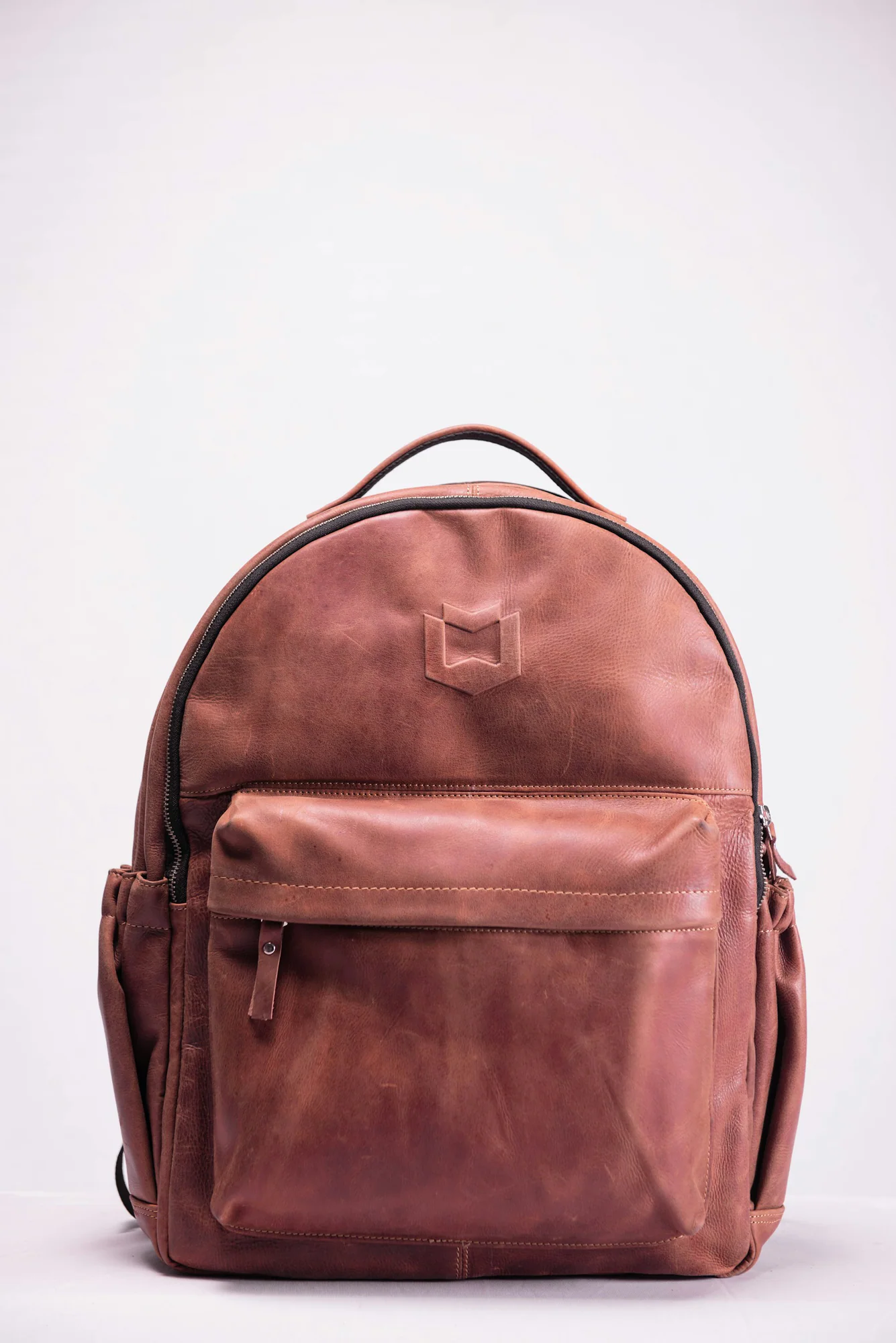 Brown leather backpack on a white background