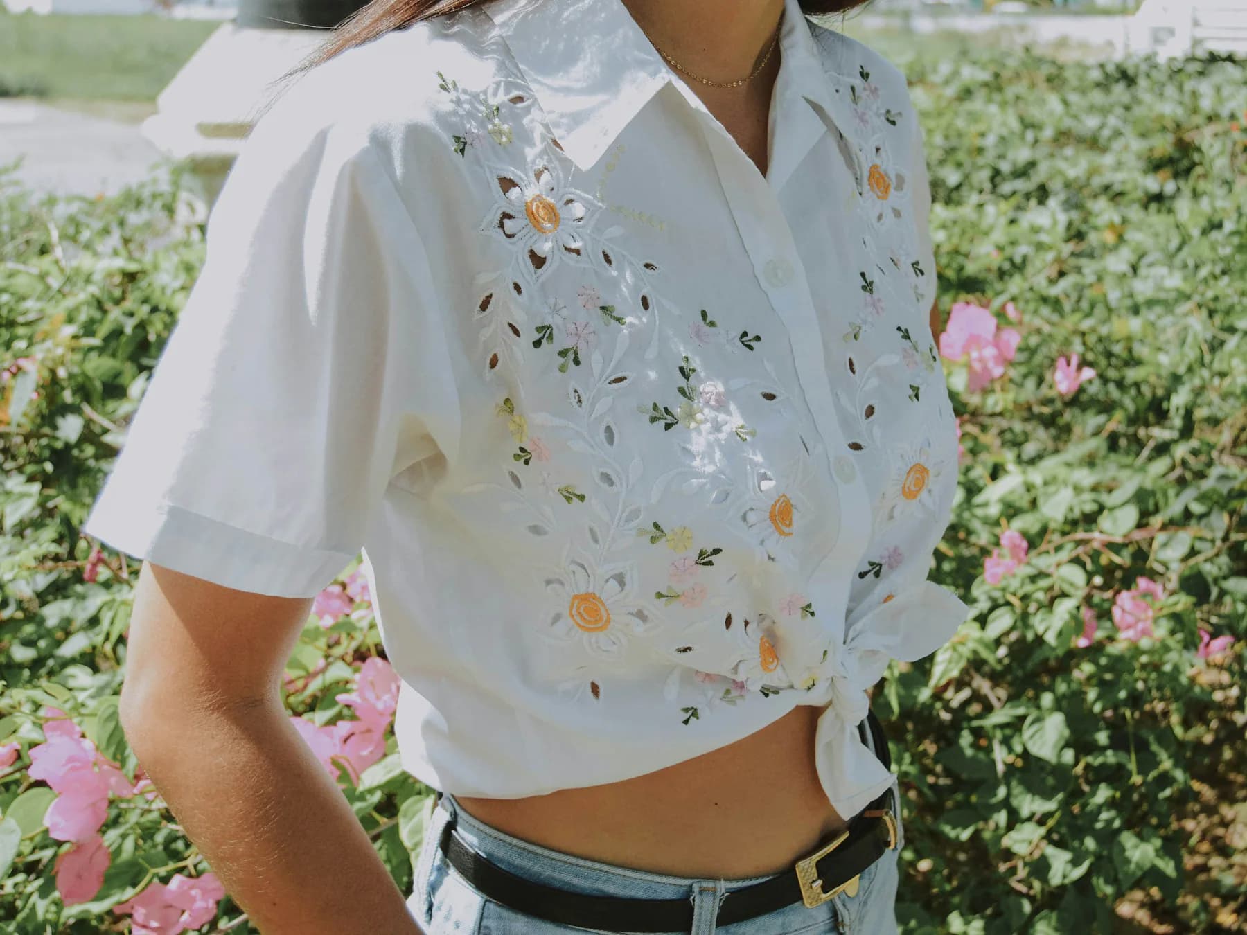 Close-up of a white blouse with floral embroidery